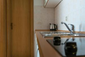 a kitchen with a sink and a stove top oven at House Vera in Baška Voda