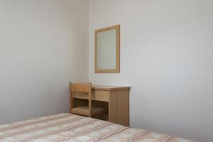 a bedroom with a table and a mirror and a bed at House Vera in Baška Voda