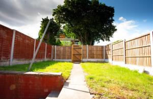 a fence with a gate and a grass yard at Room near to Birmingham city centre with parking in Birmingham
