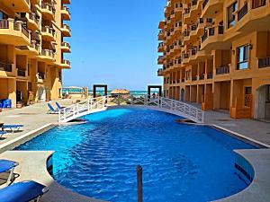 a bridge over a pool in front of some buildings at A5 8 At Turtles Beach Hurghada ok holiday homes in Hurghada