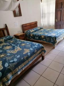 Säng eller sängar i ett rum på Posada Bugambilias