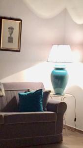 a lamp sitting on a table next to a couch at Casa da Verrazzano in Florence
