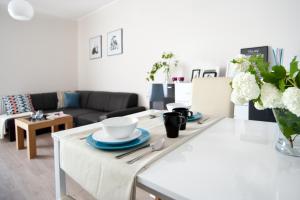 a living room with a table with plates on it at Apartament Luxon 2 in Kielce +17 photos