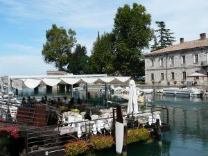 a restaurant on a boat in a body of water at Villa Pille in Monzambano