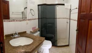 a bathroom with a toilet and a sink and a shower at Espaço Vida Mury - Casa Mara in Nova Friburgo +25 photos