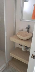 a bathroom with a sink and a mirror at Casa de las Palmas in Zihuatanejo