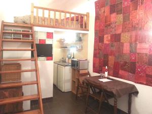 a small kitchen with a table and a bunk bed at Adorable Studette Nice Cessole in Nice