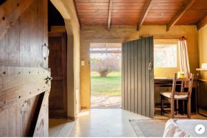 an open door to a kitchen with a table at Ranchito Macondo in San Antonio de Areco