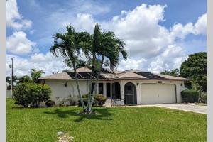 a palm tree in front of a house at The Max in Cape Coral