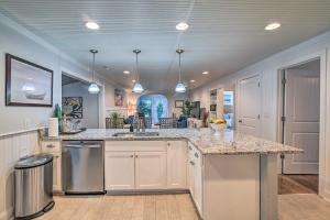 a large kitchen with a counter top and a kitchen island at Bright and Sunny Escape 14 Mi to Myrtle Beach! in Myrtle Beach