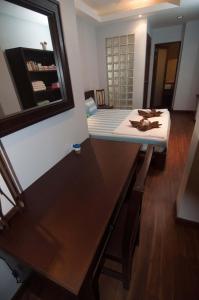 a room with a table and a bed with a mirror at Penn Sunset Villa 10 with Shared Pool in Ko Lanta
