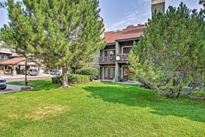 a house with two trees in front of a yard at Contemporary Family Condo by Pineview Reservoir! in Huntsville
