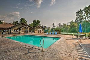 a swimming pool in front of a house at Contemporary Family Condo by Pineview Reservoir! in Huntsville