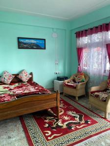 a bedroom with a bed and a couch and a chair at B&B Homestay in Darjeeling