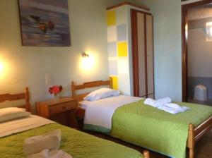 a hotel room with two beds with towels at Studios LaLu in Skiathos