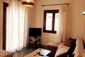 A television and/or entertainment centre at Xristina's Experience