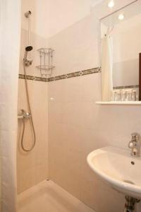 a bathroom with a shower and a sink at Rooms Amfora in Krk