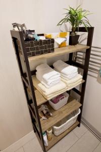 a shelf with towels and towels on it at K-HOUSE Naha Maejima in Naha