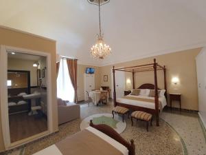 a bedroom with a bed and a living room at B&B Giardino delle Delizie in Gravina in Puglia