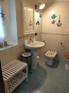 a bathroom with a sink and a toilet at Lo scrigno di Simon in Senigallia