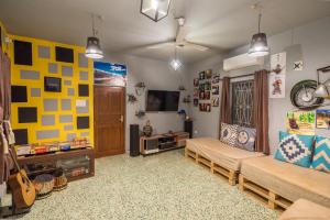 a living room with two couches and a tv at U.R.D.Ki Hostel in Anjuna