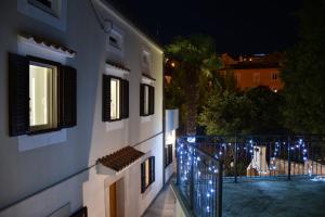 a building with lights on the side of it at night at Vila Palma in Vrbnik