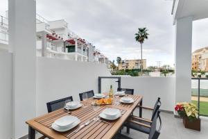 a dining room with a table and chairs on a balcony at Casa Tumry in Denia
