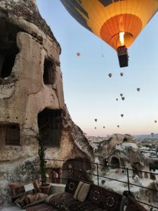 a hot air balloon flying over the city at Zeus Cave Suites in Goreme