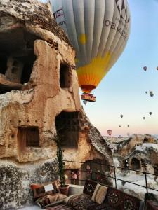 un groupe de ballons à air chaud volant dans le ciel dans l'établissement Zeus Cave Suites, à Gorëme