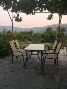 a table and four chairs sitting around a table at Guesthouse "Athina" in Ellinikón