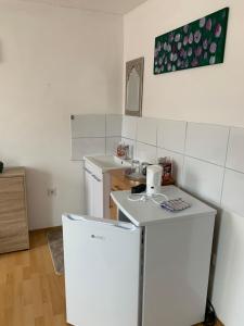 a kitchen with a white refrigerator and a sink at Privat Zimmer KF in Knittelfeld