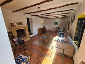 a living room with a couch and a fireplace at Cortijo Las Rodrigas in Sabariego