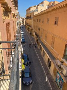a street with cars parked on the side of a building at Ostro - Guest House in Agrigento