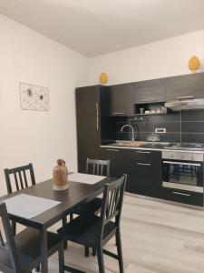 a kitchen with a table and chairs in a room at Ostro - Guest House in Agrigento