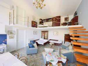 a living room with a blue couch and stairs at Coco's Apartment in Meta