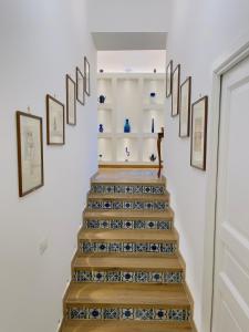 a staircase with blue and white vases on the wall at Coco's Apartment in Meta