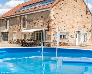 a house with a pool in front of it at Gîte La Fontagrille in Épineuil-le-Fleuriel