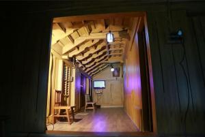 a hallway of a house with a room with wooden ceilings at NATURE CASTLE -Traditional villa,Vattavada in Kottakamboor