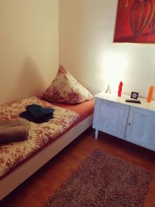 a bedroom with a bed and a dresser with a lamp at CrisAnd 2 Bergen in Altenau +23 photos