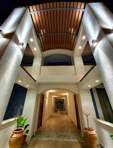 a hallway of a building with a wooden ceiling at Eleni Beach Apartment in Stalida