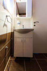 a bathroom with a sink and a mirror at Hostel Sunset in Zadar