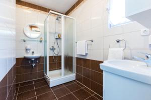 a bathroom with a shower and a sink at Hostel Sunset in Zadar +19 photos