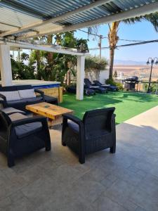 a patio with a ping pong table and chairs at Beit Nofesh in Tiberias