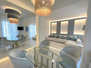 a living room with a couch and a table and chairs at Luxury Home Paradise View in Forte dei Marmi