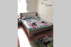 a bedroom with a bed with a quilt on it at Apartman Kadić Senj in Senj