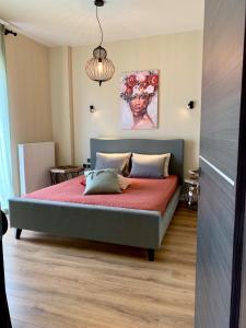 a bedroom with a bed with a red bedspread at SIMONE LUXURY SUITE, Central Modern Apartment 82sqm with Terrace in Tripolis