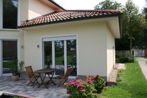 a patio with a table and chairs in front of a house at Business Lounge Potsdam in Potsdam +10 photos