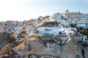 a view of a village on the side of a mountain at Pearl of Caldera Oia - Boutique Hotel by Pearl Hotel Collection in Oia