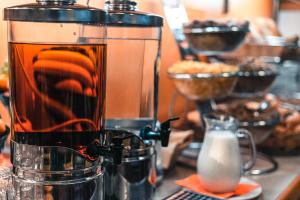 a blender sitting on top of a counter with food at Hotel Malta in Karlovy Vary