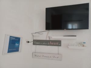 a flat screen tv hanging on a wall at Apartmani Jakovljevic in Murter